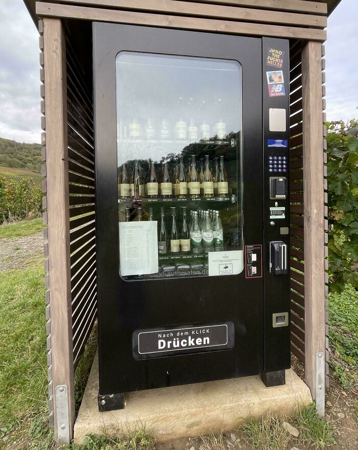Vending machine selling wine bottles outdoors in a vineyard, showcasing small but genius things some countries do.