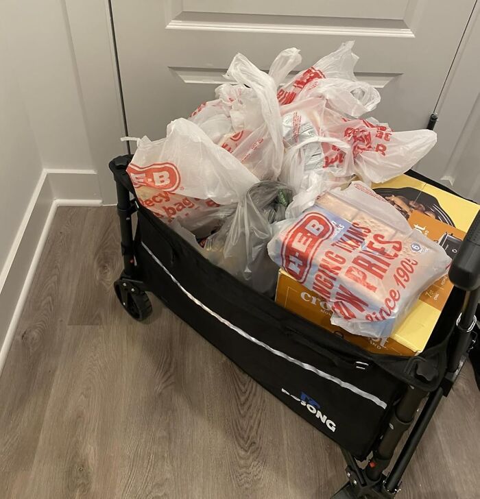 Foldable shopping cart filled with groceries and plastic bags, popular among the most wished for items on Amazon.