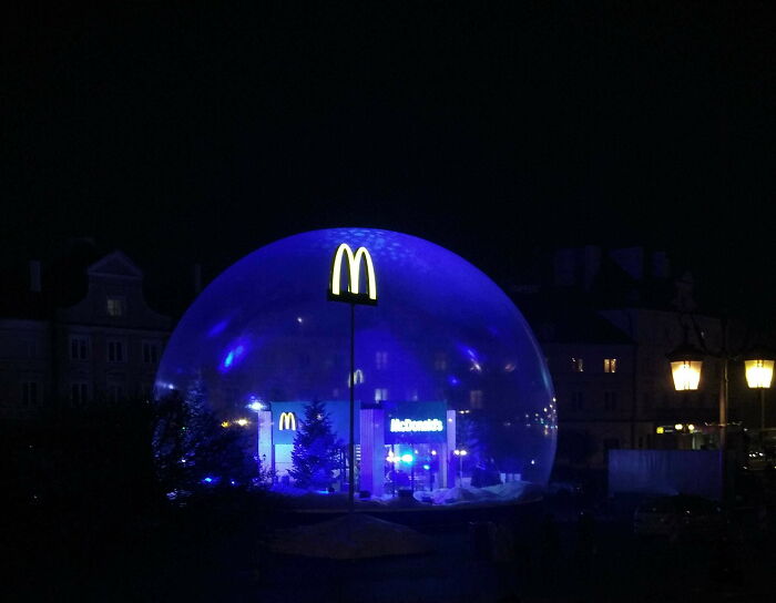 McDonald's restaurant inside a large transparent dome at night, showcasing small genius innovations some countries do.