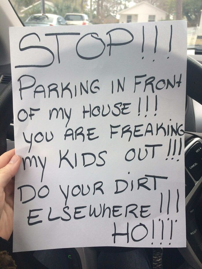 Handwritten unhinged neighbor's note demanding to stop parking in front of their house, reflecting difficult living among neighbors.