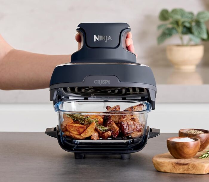 Ninja CRISPi air fryer oven cooking crispy roasted potatoes and meat, popular most wished for items on Amazon this week.