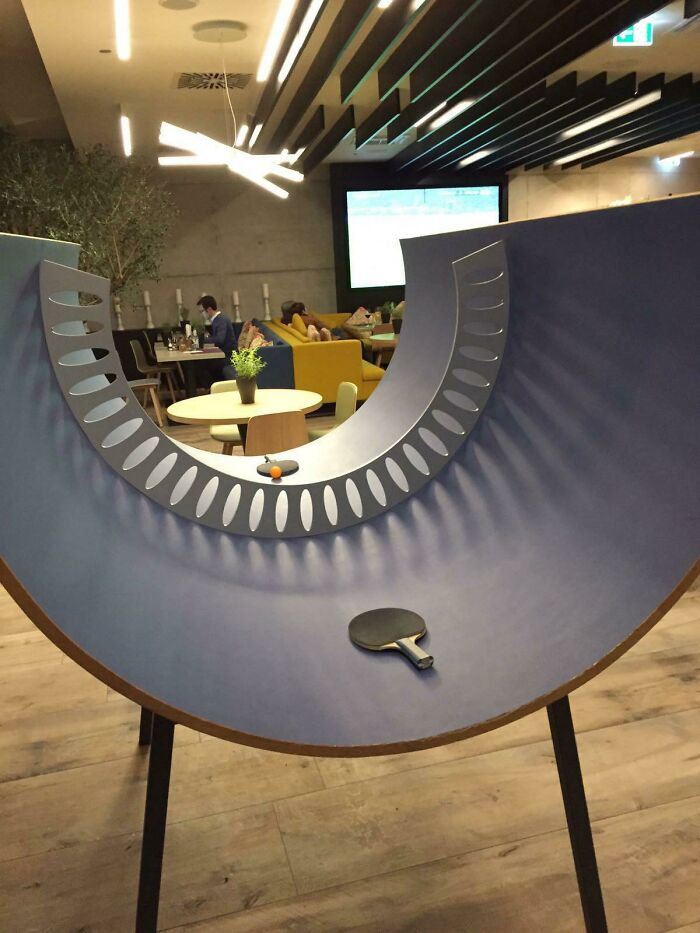 Innovative curved ping pong table design in a modern lounge showing small genius things some countries do immediately.