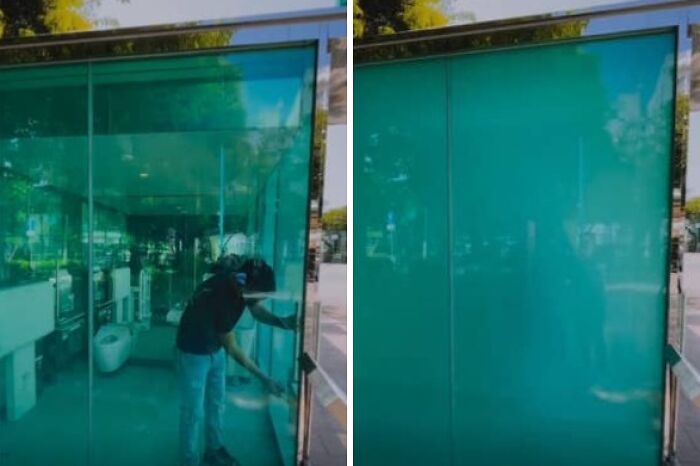 Person interacting with a transparent public restroom feature, showcasing small genius things some countries do.