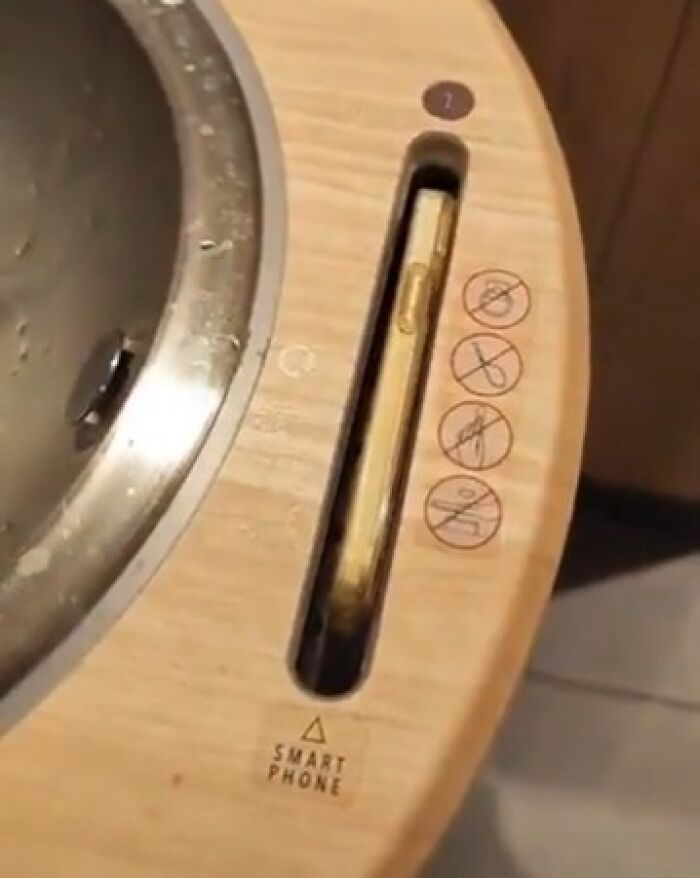 Smartphone slot integrated into a sink counter for safe drying, showcasing a small but genius thing some countries do.