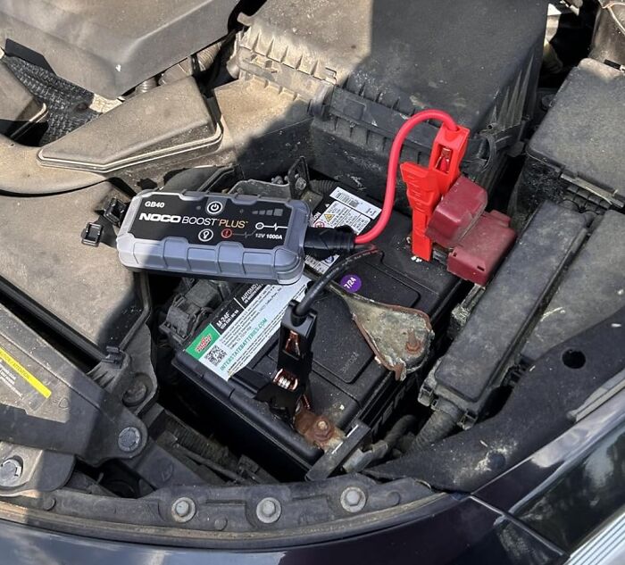 Portable battery jump starter connected to a car battery, one of the most wished for items burning up Amazon this week.