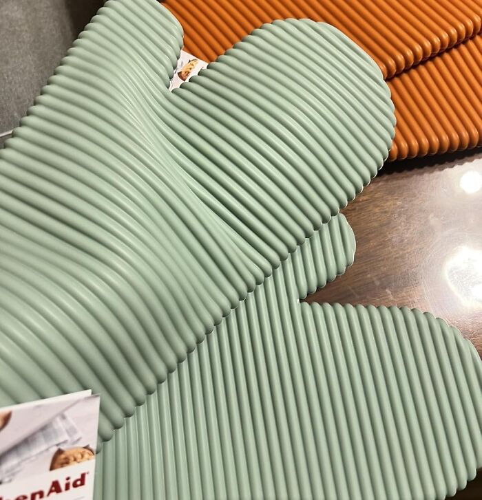 Silicone oven mitts with ribbed texture in green and orange, popular kitchen items burning up Amazon this week.