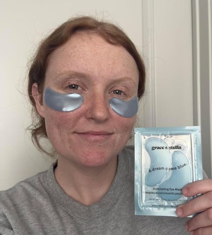 Person wearing metallic eye masks, holding a packet of skincare product featured among most wished-for items on Amazon.