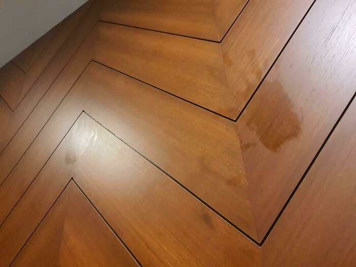 Close-up of uneven wooden panels on a hotel wall showing poor craftsmanship and design mistakes in hotels.