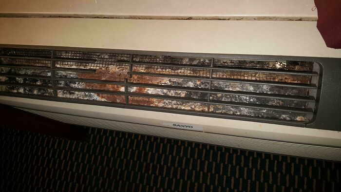 Rusty and dirty heating vent in a hotel room showing poor maintenance and cleanliness issues by hotels messing up badly.