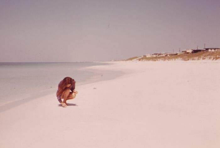 Woman on a quiet Florida beach in the 1970s, representing women in Florida breaking barriers during that era.