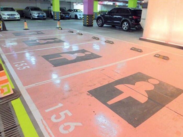 Parking spaces in a garage reserved for pregnant women, illustrating small but genius things some countries do for convenience.