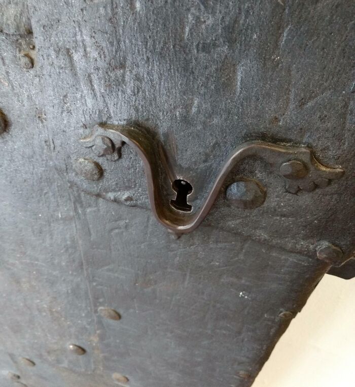 Antique metal door lock with decorative keyhole, showcasing a small but genius design from different countries.