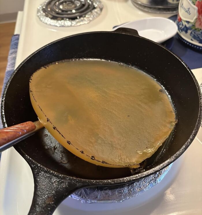 Heat-resistant silicone pan protector resting inside a cast iron skillet for specific kitchen use problems solutions.