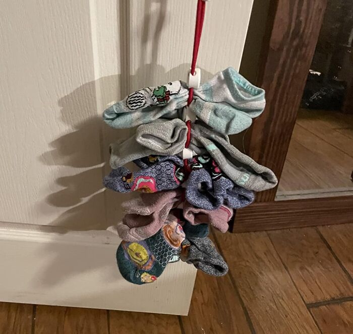 Sock organizer hanging on a door handle, showcasing a clever product for specific problems with storage and organization.