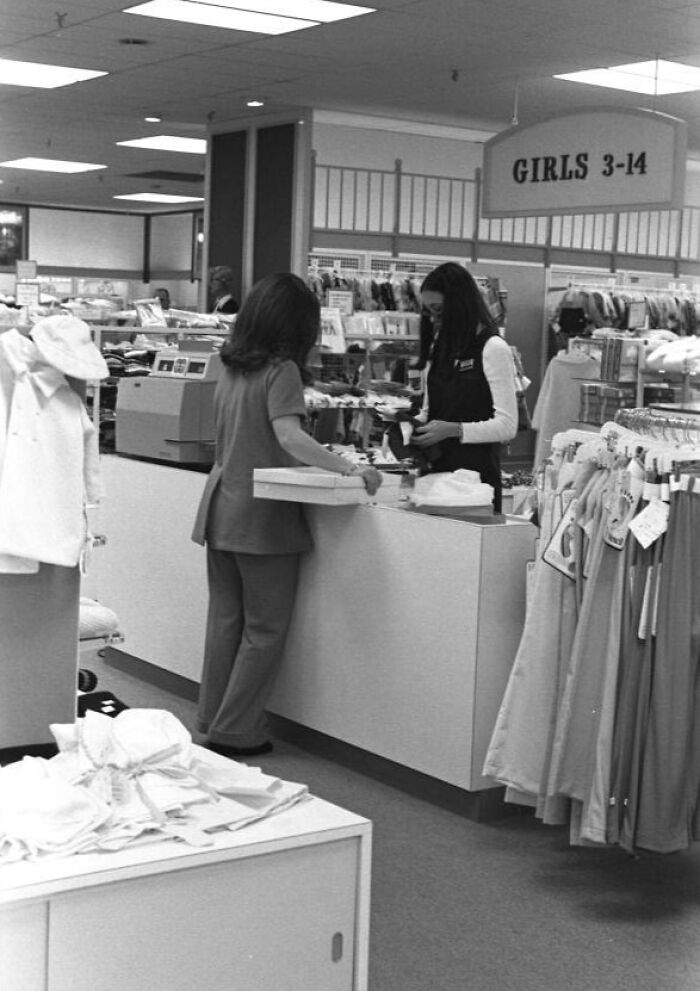 Women in Florida retail store in the 1970s breaking barriers while interacting at the checkout counter.