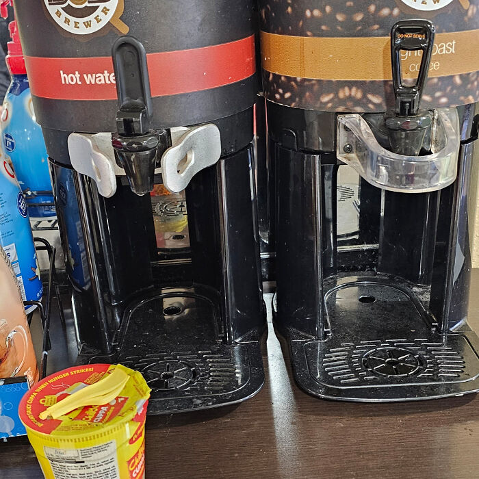 Coffee and hot water dispensers in a hotel lacking cups or lids, showing a common hotel mess-up shared online.