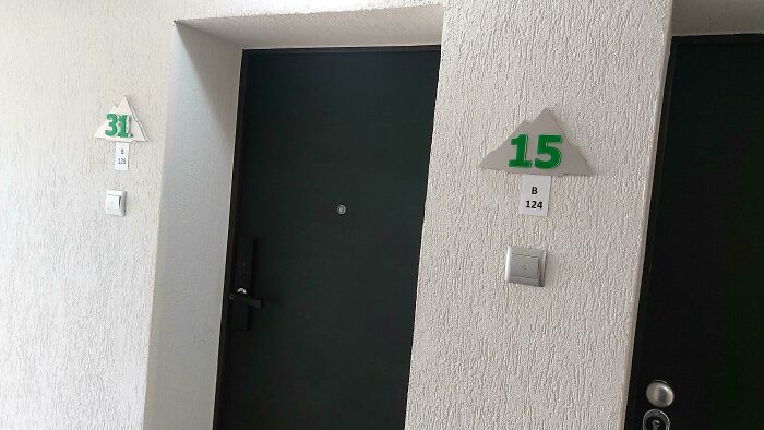 Dark hotel doors marked with room numbers 15 and 31 on white textured walls highlighting hotel mishaps.