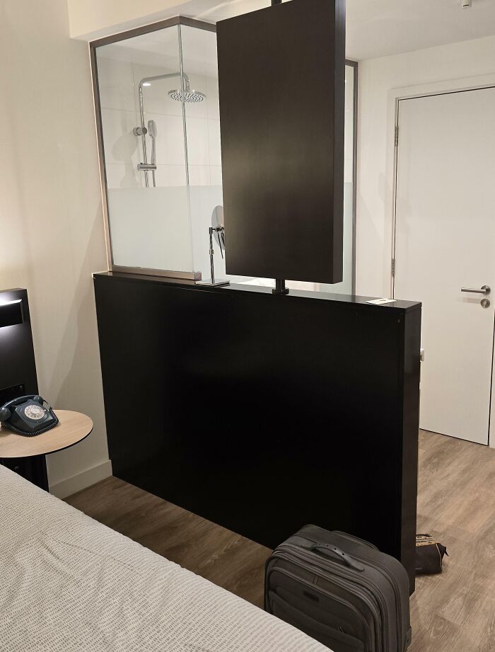 Hotel room with poorly designed partition blocking shower view, an example of hotels messed up causing guest frustration.