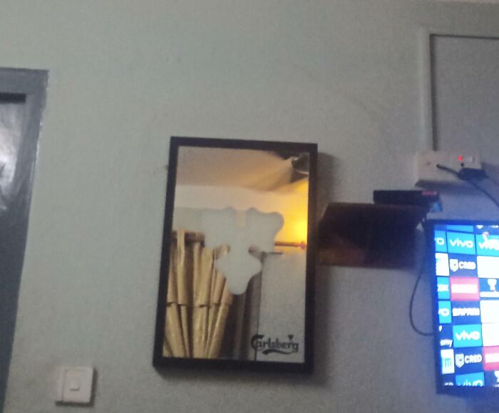 Mirror in hotel room with a large peeling stain, illustrating hotel mess up and guest frustration online.