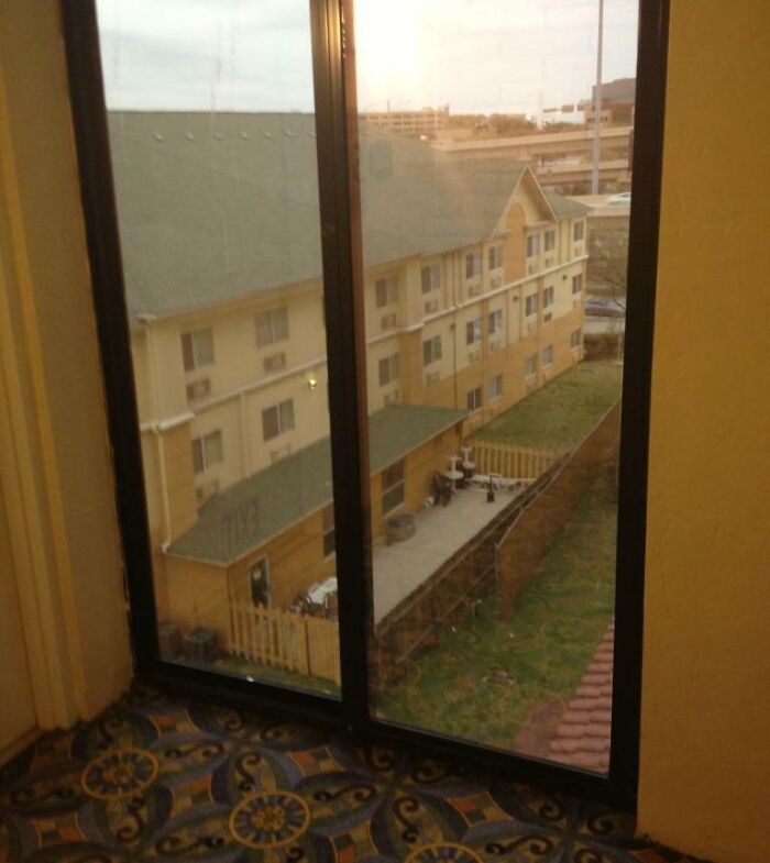 View from hotel room showing a tiny fenced patio area outside, illustrating times hotels messed up badly online complaints.