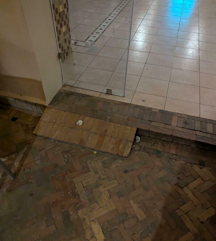 Uneven ramp made of bricks leading to a tiled hotel floor, showcasing a clear hotels mess up with poor accessibility design.