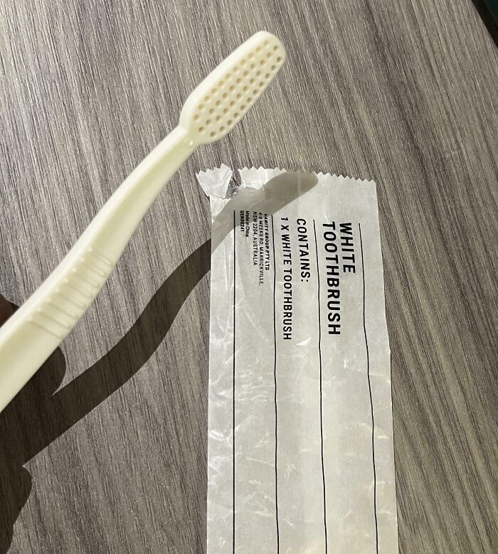 Plastic white hotel toothbrush with packaging labeled white toothbrush, highlighting a common hotel mess-up shared online.
