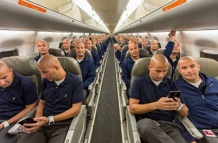 Multiple identical men seated inside an airplane cabin, showcasing an extraordinary and fascinating visual effect.