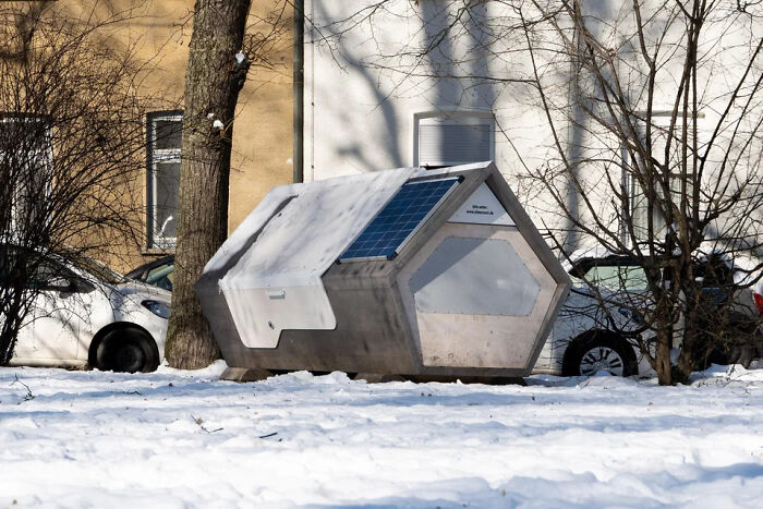 Hexagonal modern animal shelter with solar panels on snow-covered ground, an extraordinary and fascinating sight.