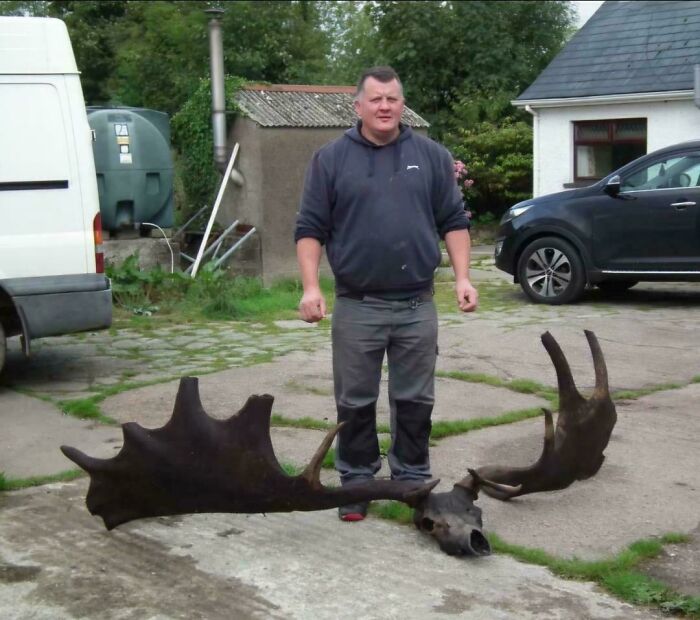 Man standing outside near large antlers on ground, an extraordinary and fascinating sight people wanted to share.