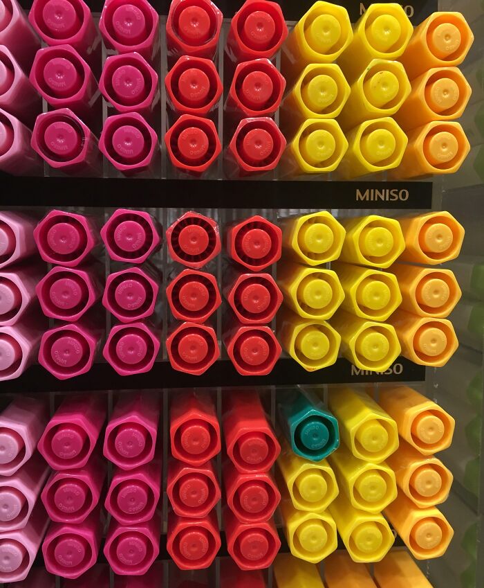 Rows of colorful hexagonal markers neatly arranged, with one marker out of place disrupting perfect order for OCD.
