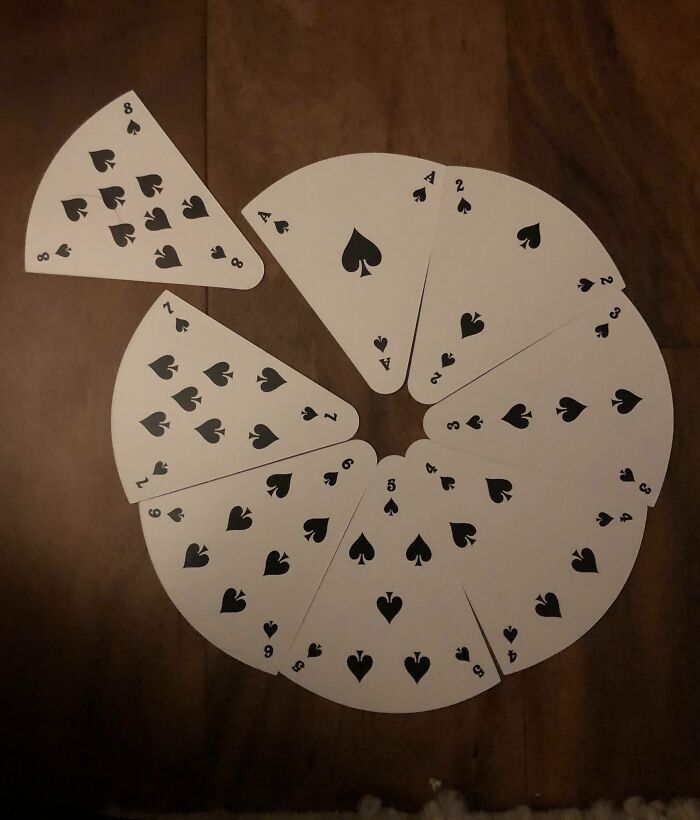 Imperfect playing cards cut into irregular shapes arranged in a circle, showing an annoyance likely for people with OCD.