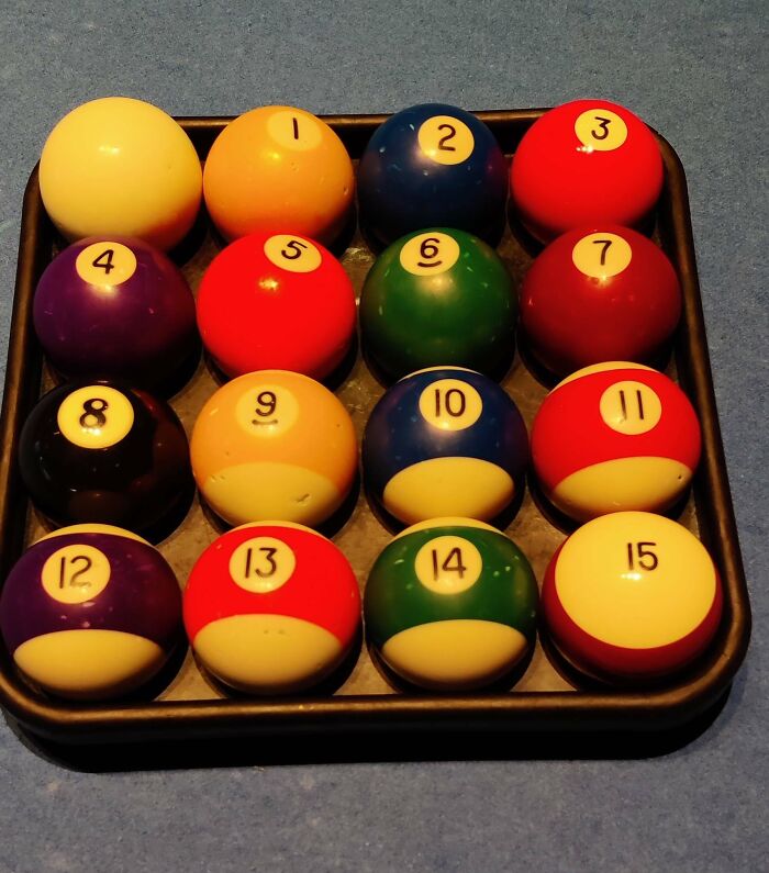 Set of numbered billiard balls arranged imperfectly in a rack, illustrating things that annoy people with OCD.