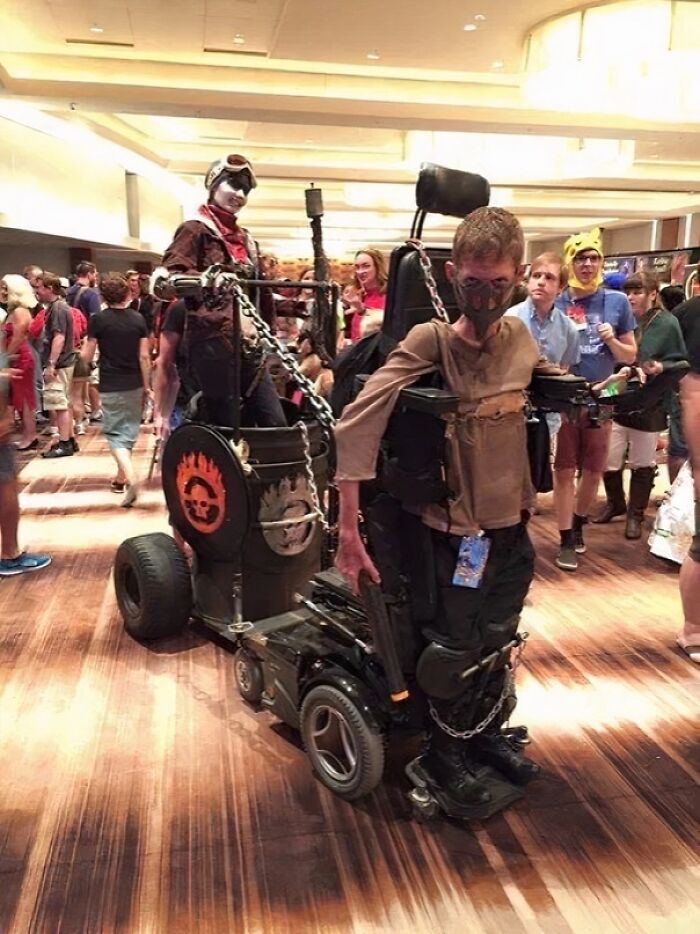 Cosplay at a convention with unique wheelchair design and elaborate costumes, spotted in extraordinary and fascinating scenes.