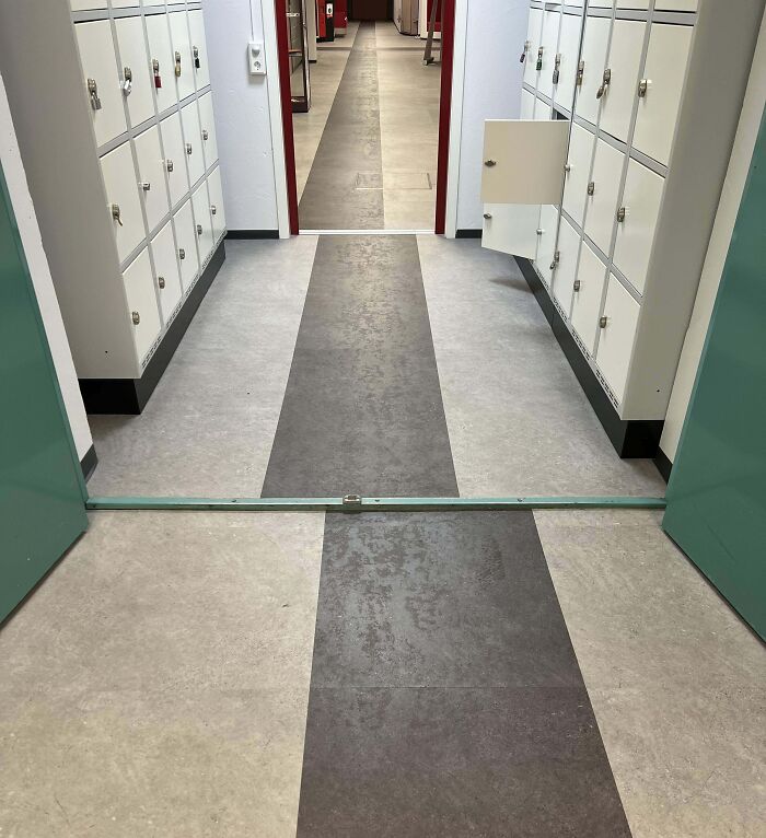 Hallway with misaligned floor patterns between two connected rooms, a detail likely to annoy people with OCD.