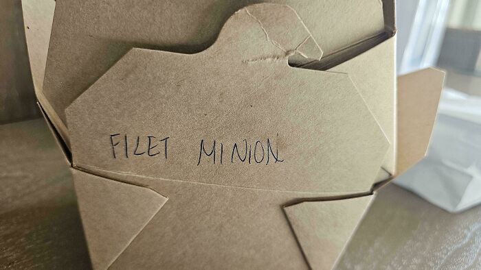Handwritten typo on a takeout box showing misspelled words, highlighting common spelling errors and typos.