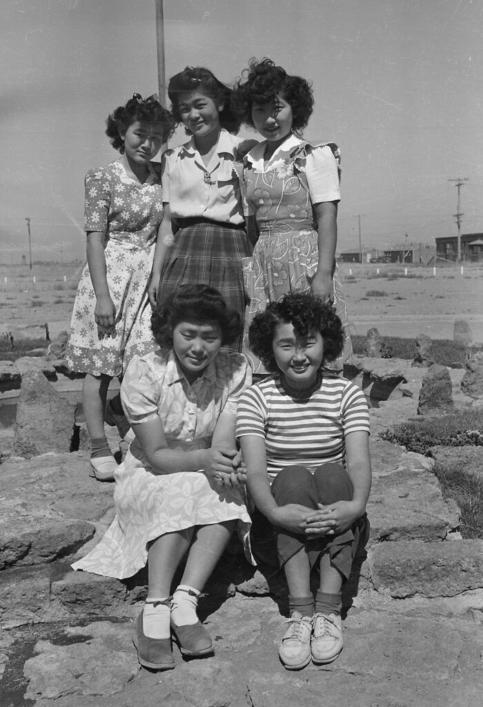 Five young girls posing outdoors in a black and white photo representing schools worldwide during World War II.