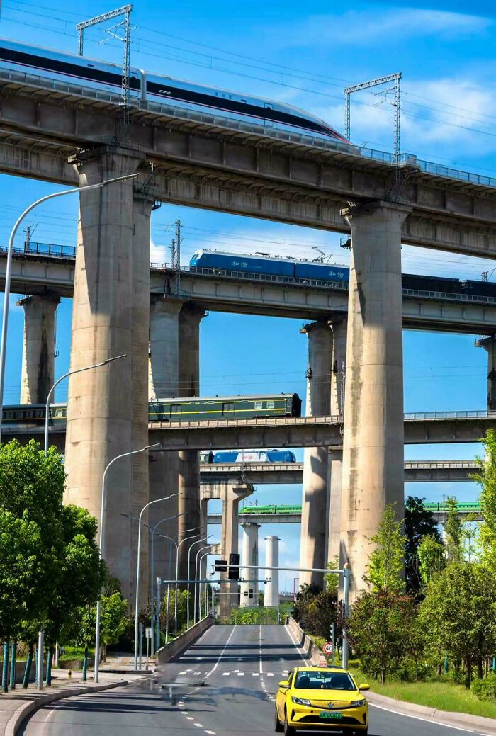 Multi-level railway bridges showcasing brilliant infrastructure with multiple trains crossing elevated concrete tracks.