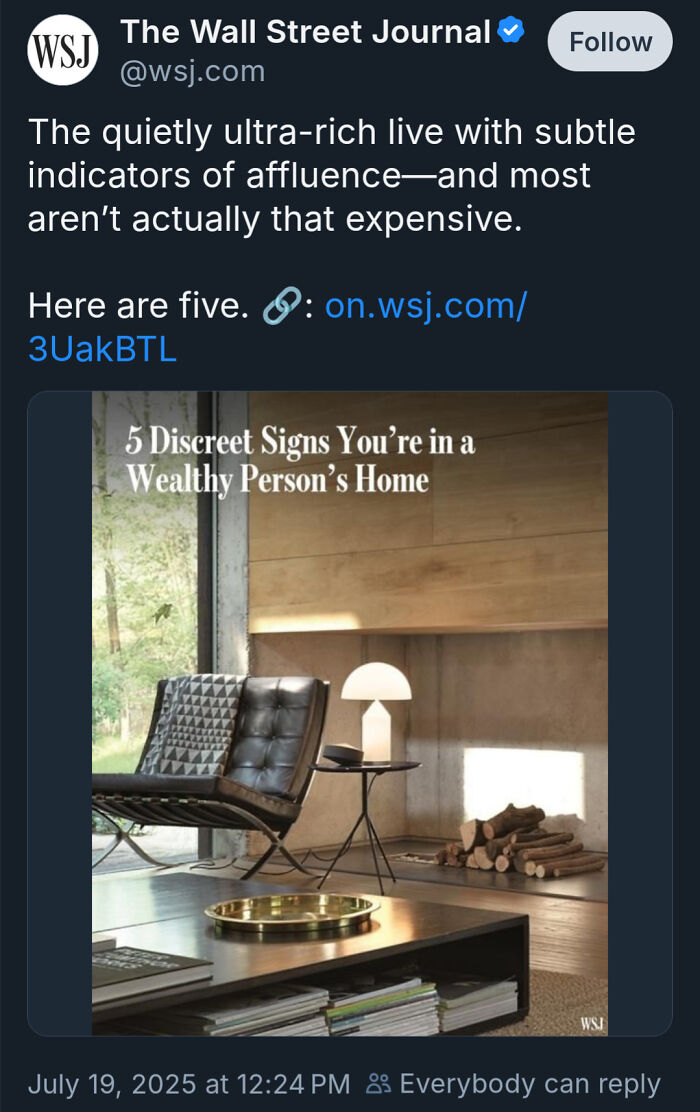 Modern living room with minimalist furniture and decor, illustrating subtle signs of consumerism and affluence.