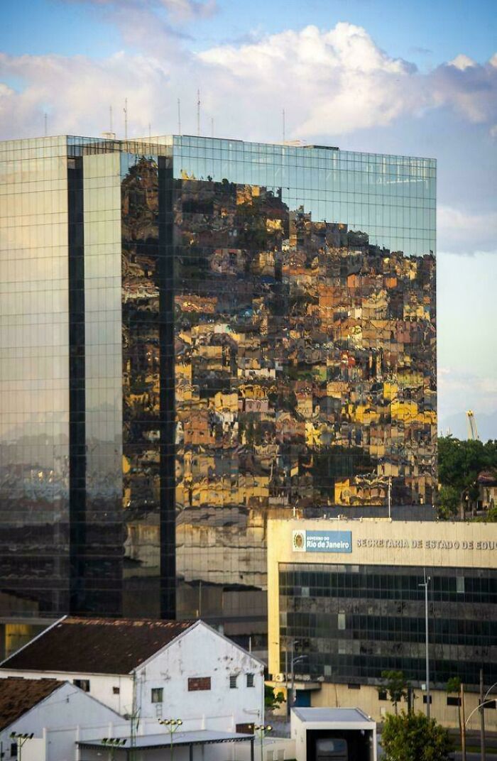 Reflection of densely packed urban area on glass skyscraper in large $58 billion ghost city setting.