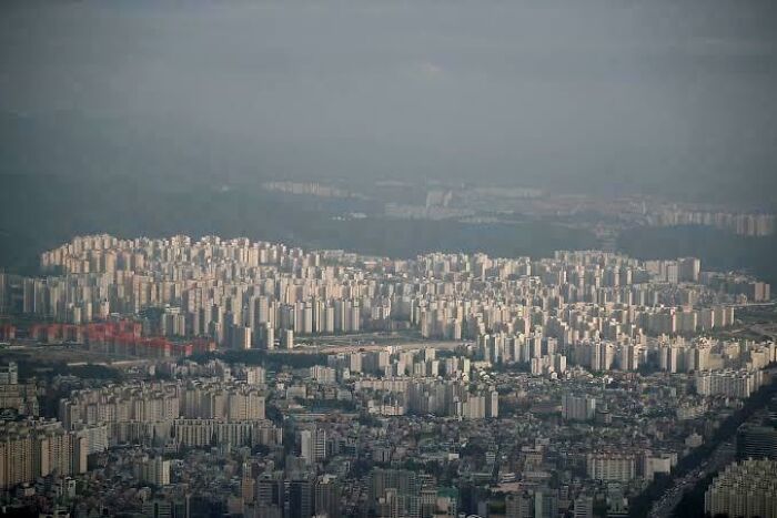 Aerial view of a massive ghost city with dense skyscrapers and empty urban spaces showing the price of modern life.