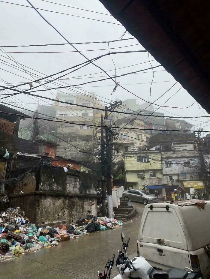 Dilapidated urban street with tangled power lines and scattered trash, depicting a $58 billion ghost city scene.