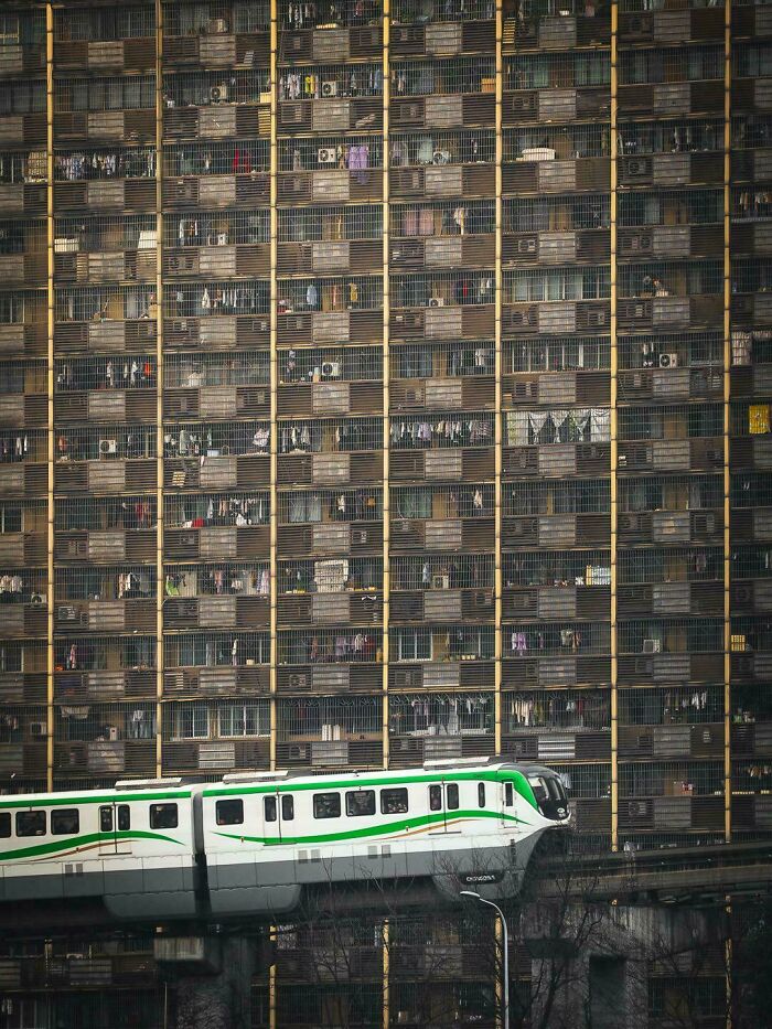 High-density urban housing with a train passing by, illustrating a $58 billion ghost city and modern urban life challenges.