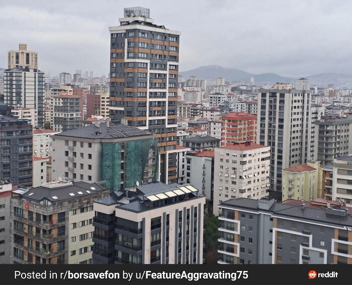 Dense urban buildings under a cloudy sky illustrating urban hell and the challenges facing modern city society.