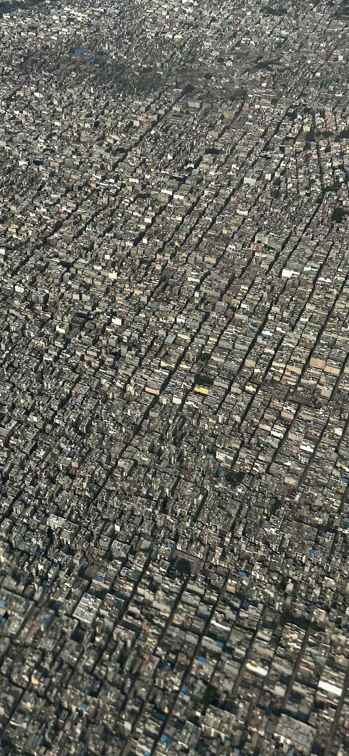 Aerial view of a densely packed $58 billion ghost city showing endless rows of buildings and urban congestion.