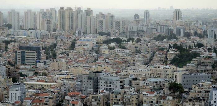 Dense urban landscape showing overcrowded buildings and congestion highlighting urban hell and societal issues.