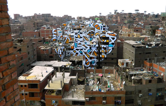 Aerial view of a $58 billion ghost city with densely packed abandoned buildings and rubble in an urban hell environment.