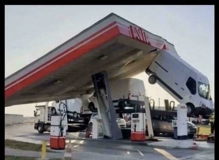 A gas station canopy collapses onto a truck carrying other vehicles, causing a major accident. Fails and accidents.