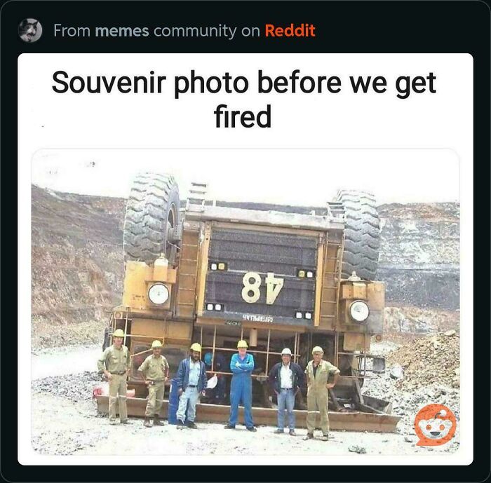 Miners pose in front of a giant overturned mining truck. A clear example of an accident that looked expensive.