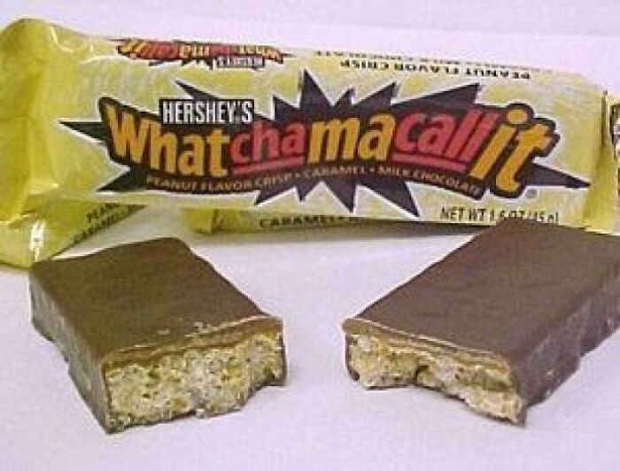 Hershey’s Whatchamacallit candy bar broken in half showing nostalgic treat from old snacks collection.