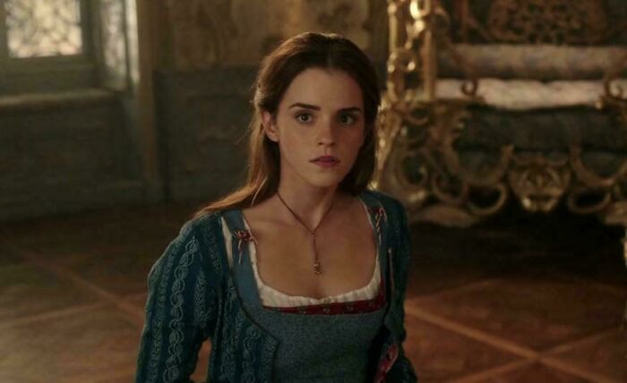 Young woman in period costume looking surprised in a dimly lit room, representing bad movie details and confusing scenes.